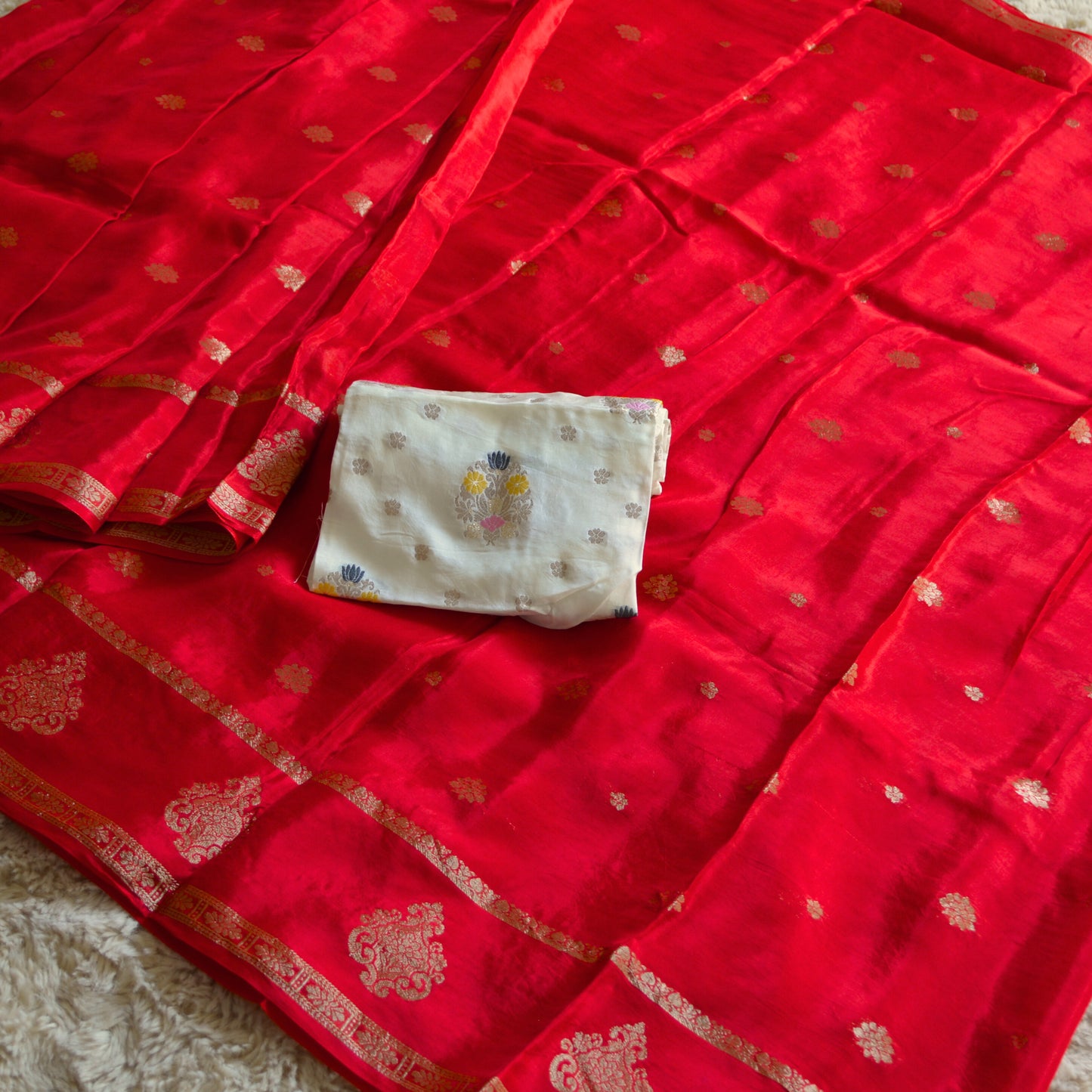 red and half white chinnon butta border saree