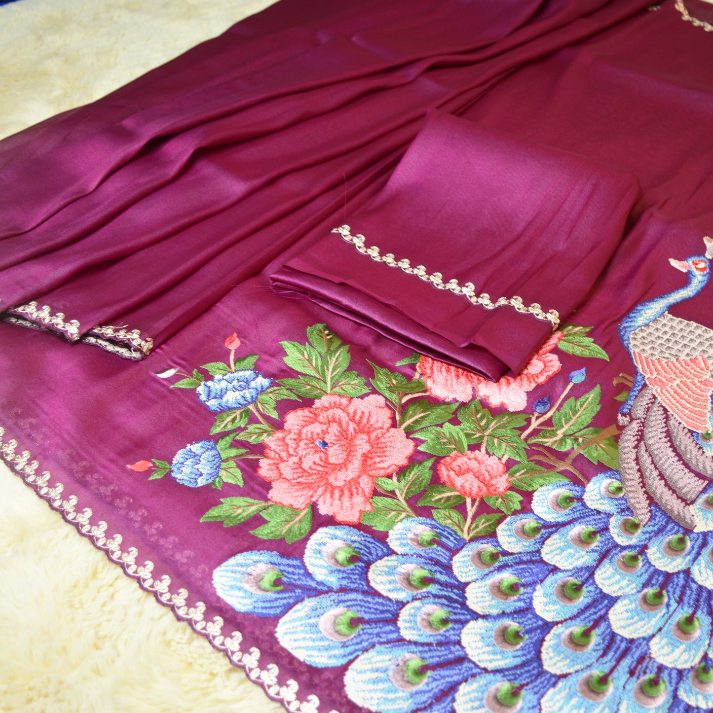Magenta tissue saree with peacock embroidery.
