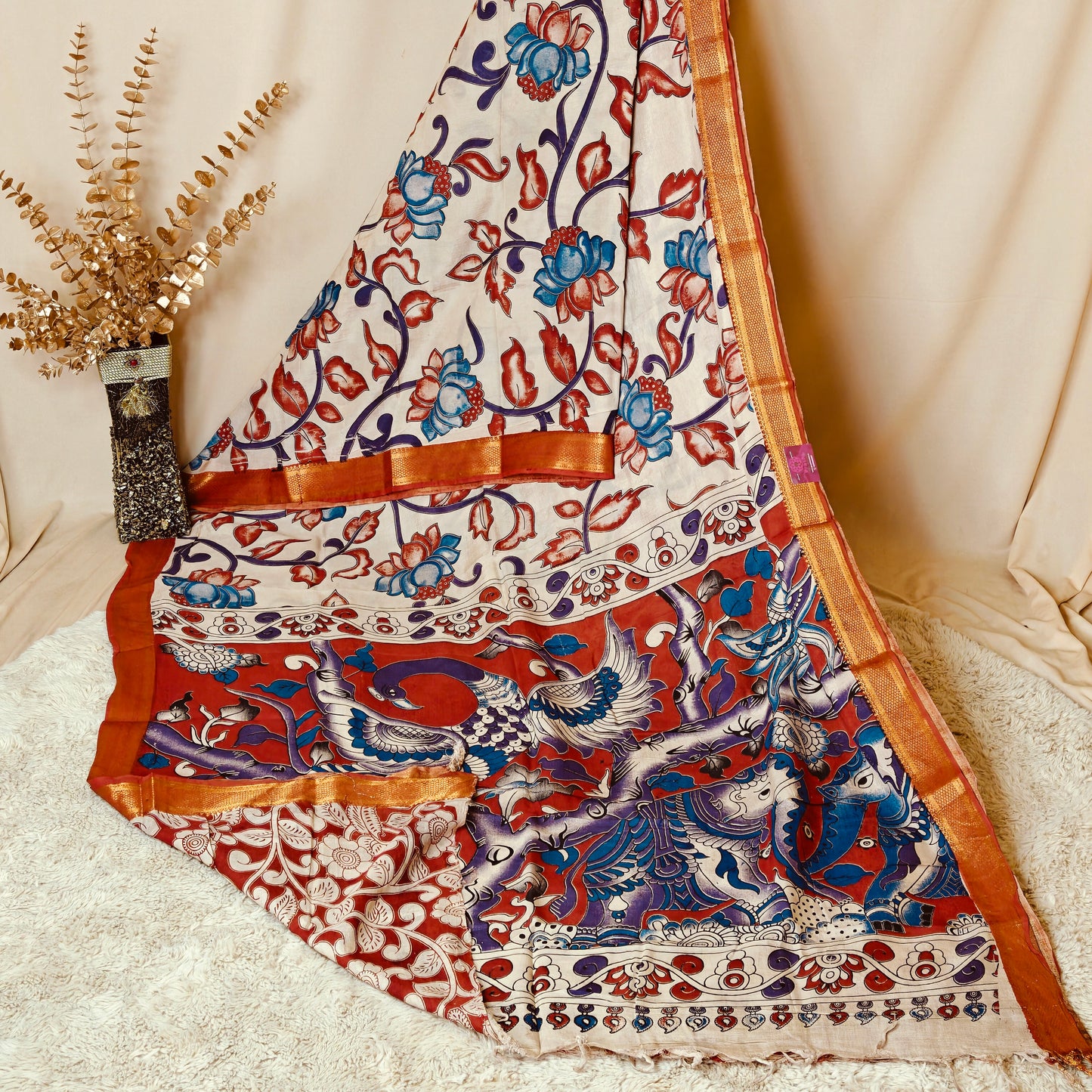 Half-white with orange kalamkari silk saree