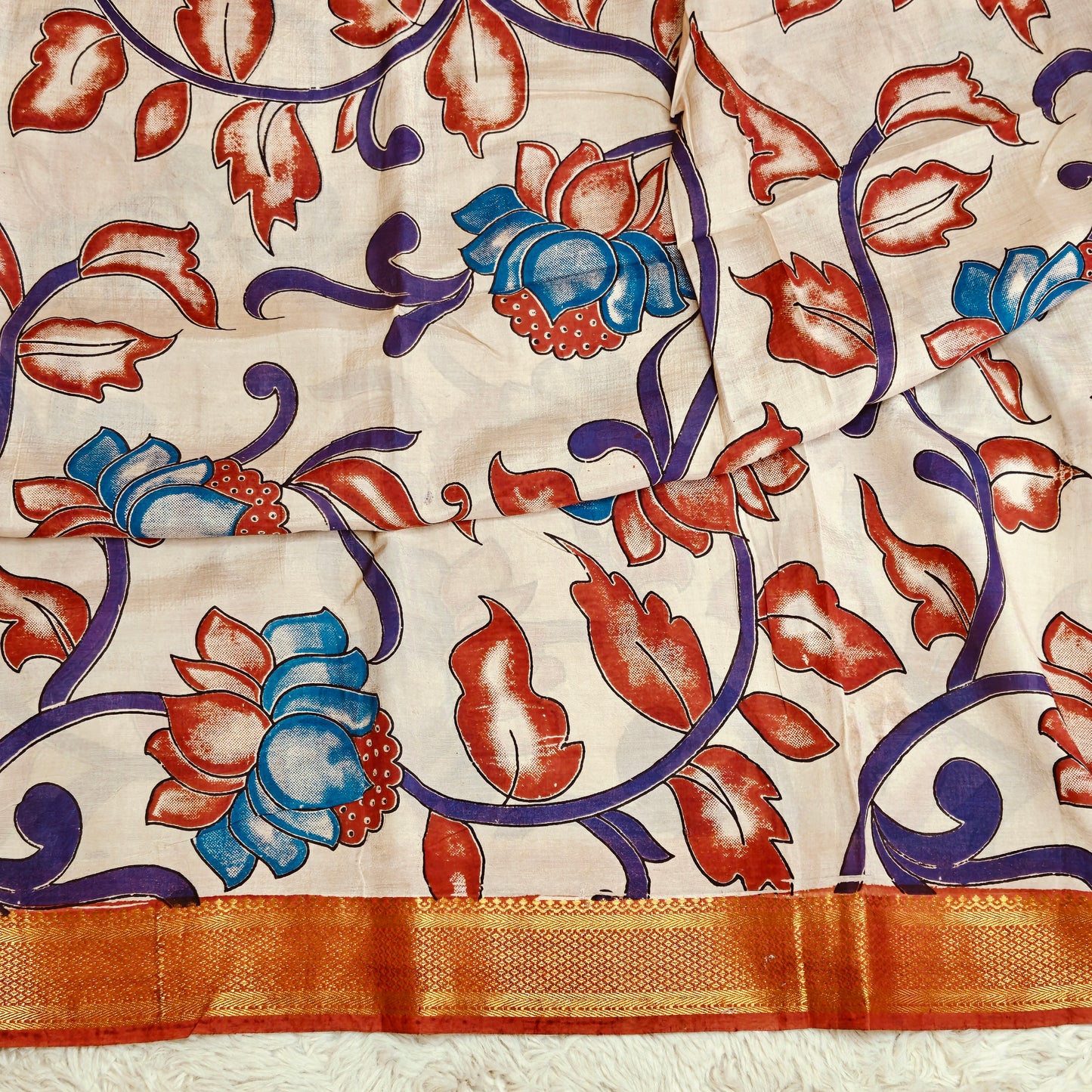 Half-white with orange kalamkari silk saree