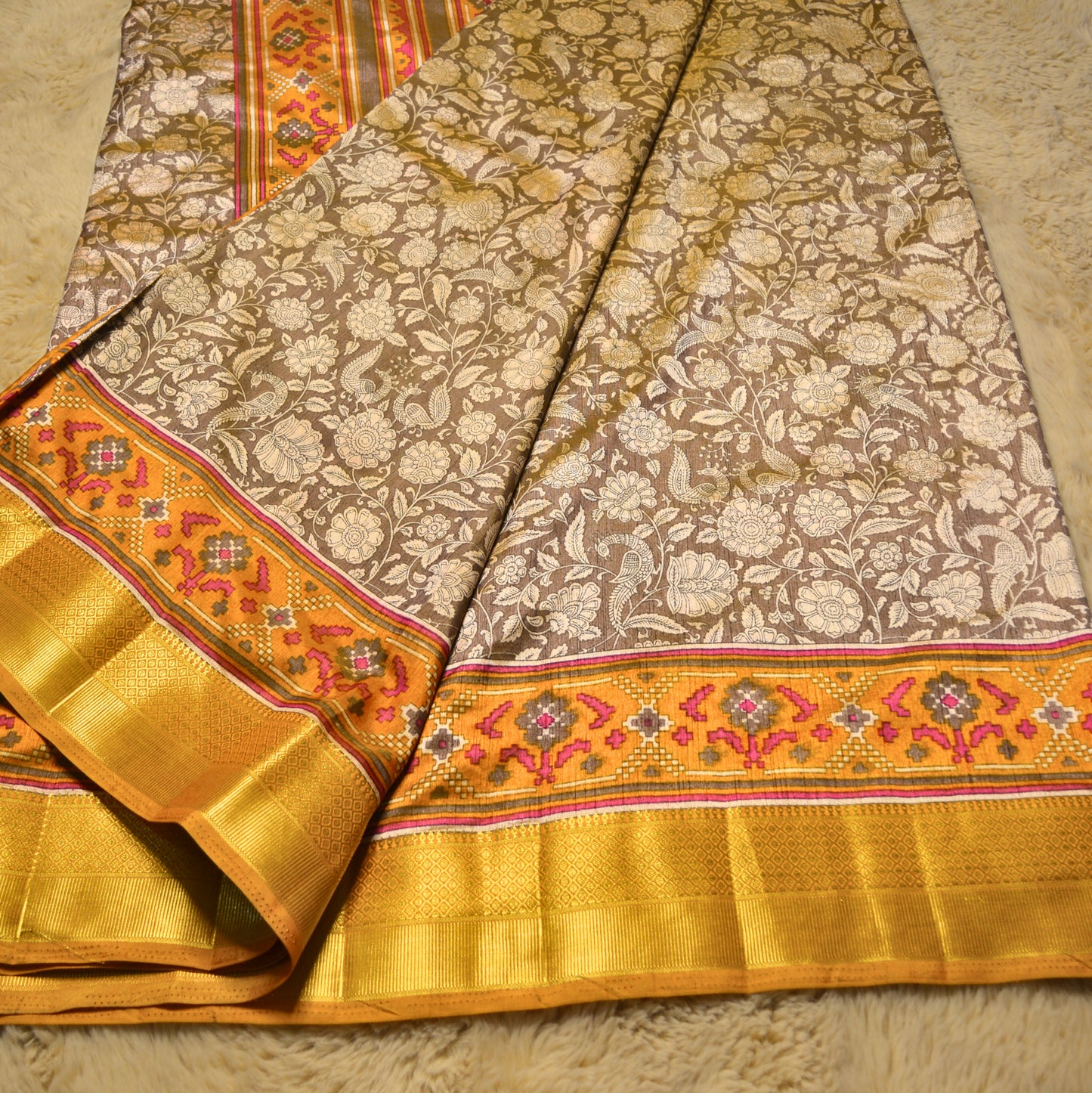 Beige with yellow patola saree